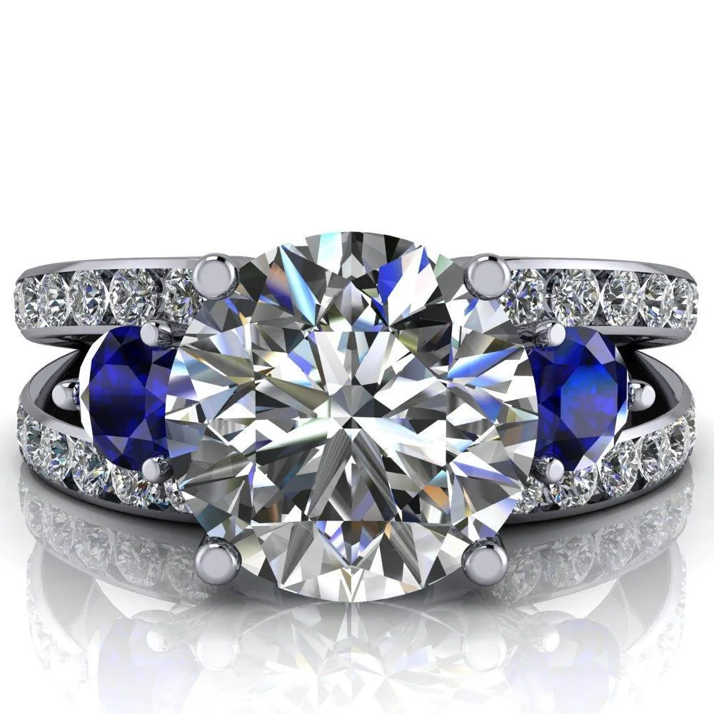 Orion Round Center Stone 2 Round Blue Sapphire Sides Split Shank Diamond Channel Set Ring