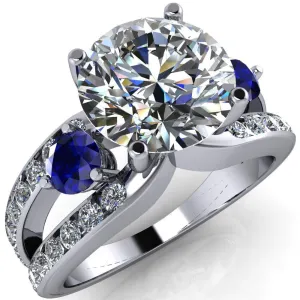 Orion Round Center Stone 2 Round Blue Sapphire Sides Split Shank Diamond Channel Set Ring