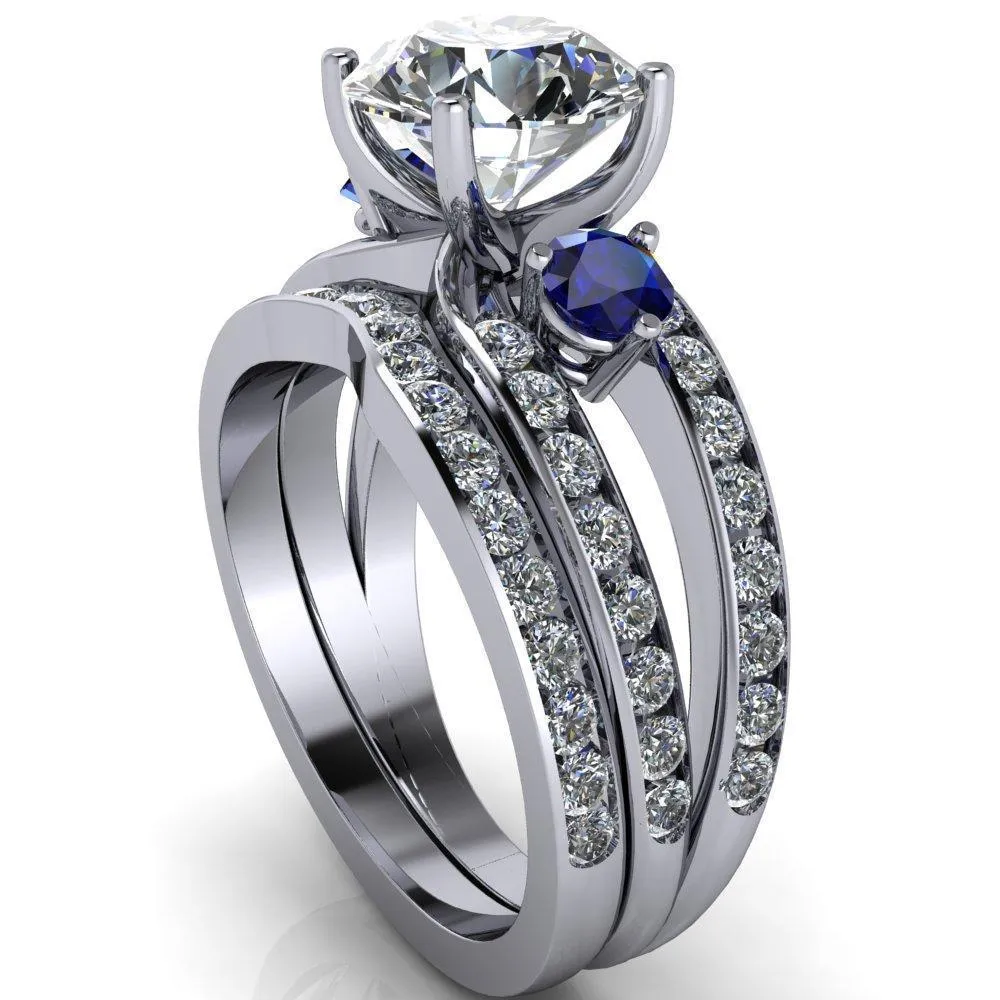 Orion Round Center Stone 2 Round Blue Sapphire Sides Split Shank Diamond Channel Set Ring