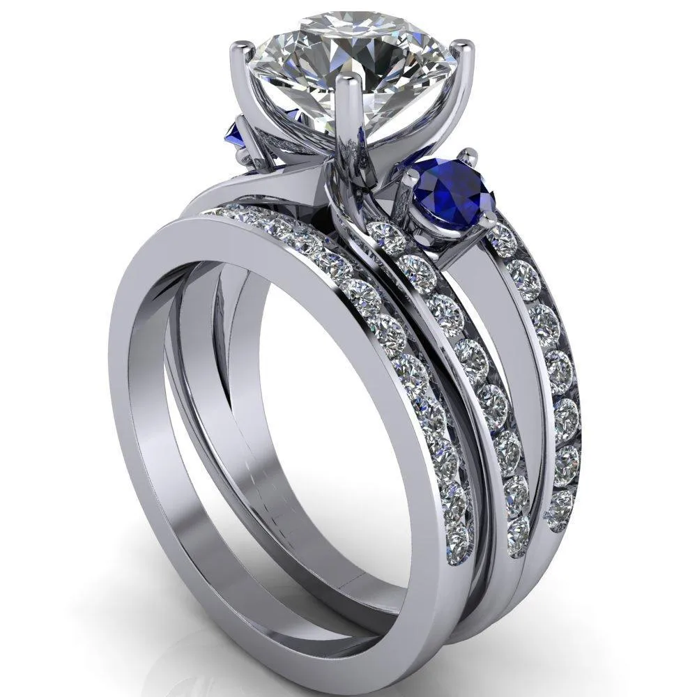Orion Round Center Stone 2 Round Blue Sapphire Sides Split Shank Diamond Channel Set Ring